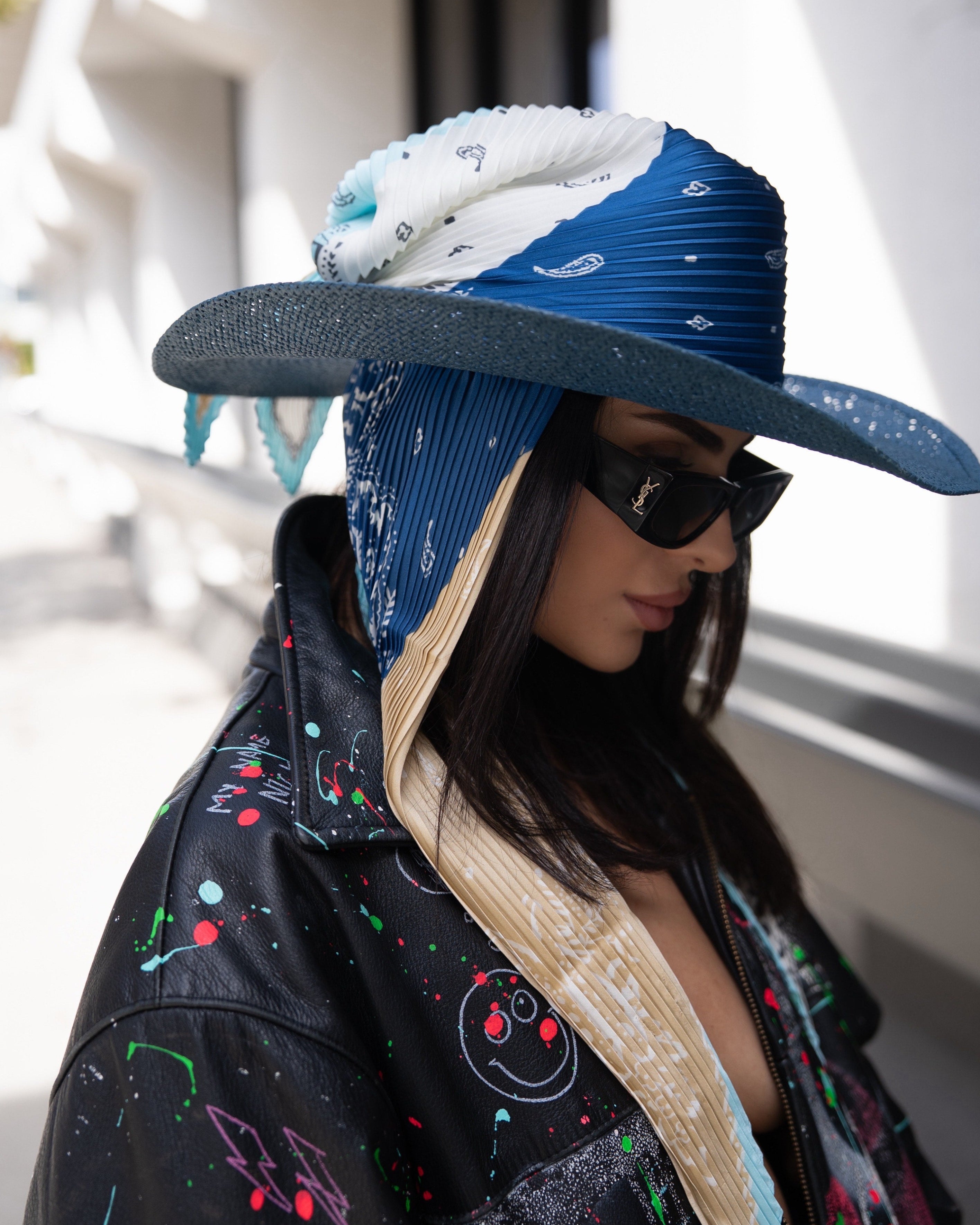 Model wearing the Texas Allure straw hat with silk scarf, combining strong structure with refined western-inspired style.